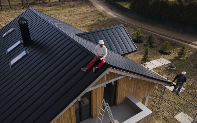 long-shot-man-with-helmet-sitting-roof