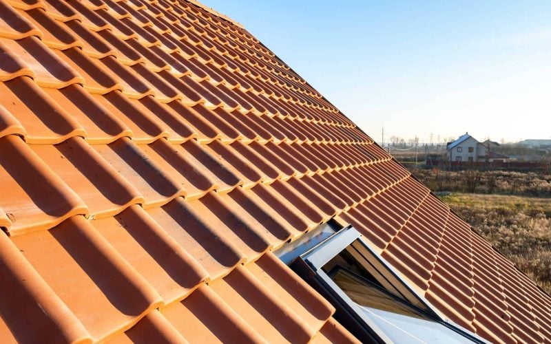 overlapping-rows-of-yellow-ceramic-roofing-tiles-covering-residential-building-roof.jpg