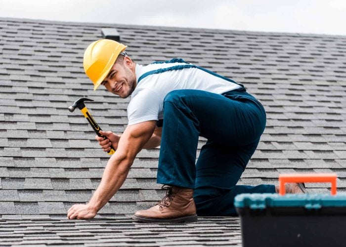 selective-focus-of-handsome-handyman-repairing-roof.jpg