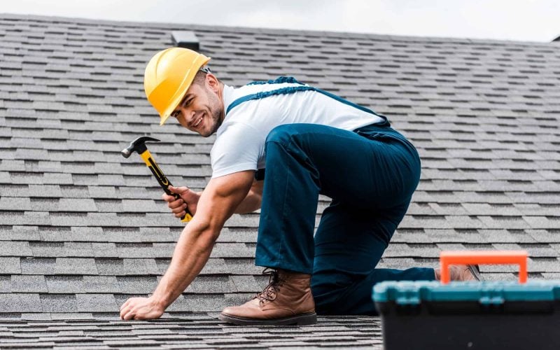 selective-focus-of-handsome-handyman-repairing-roof.jpg