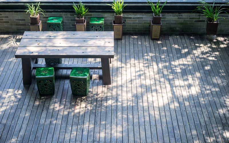 chairs and a table in a small wood platform